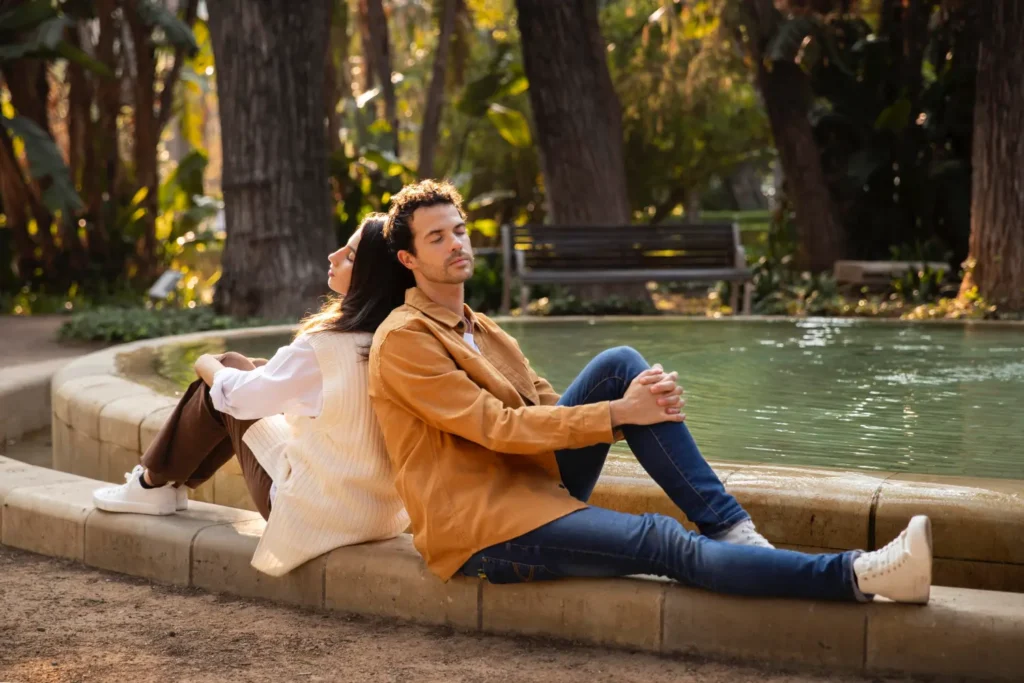 Couple relaxing near a fountain in a park